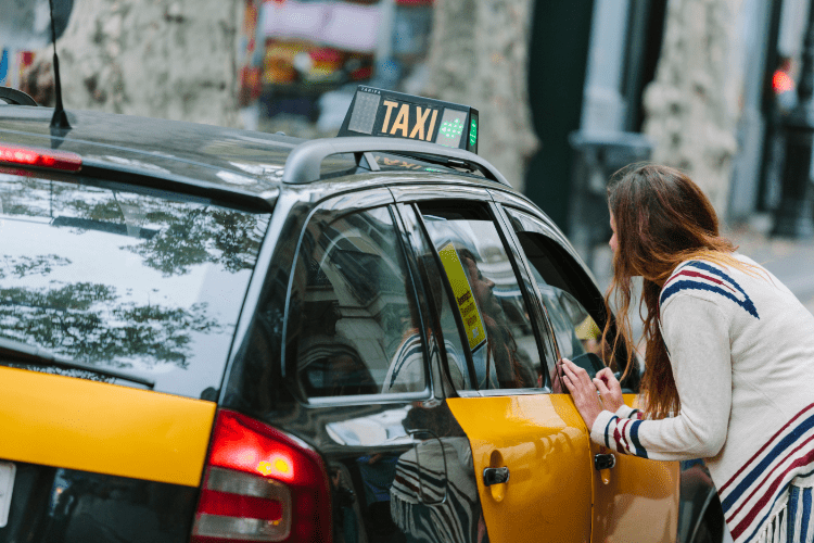 a black and yellow taxi barcelona